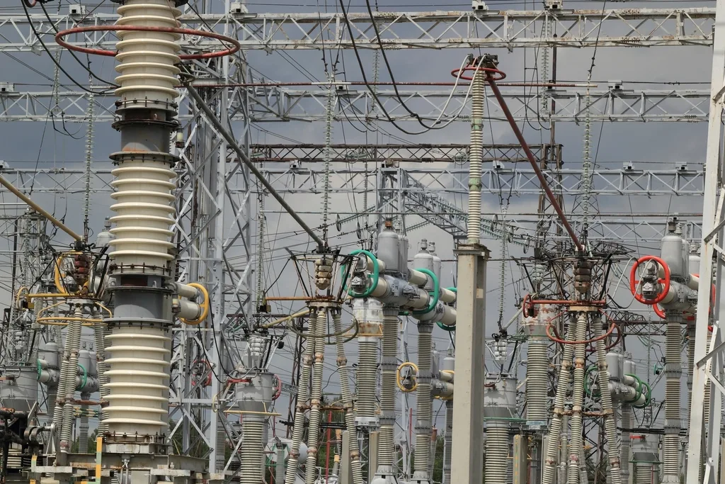 Insulators and busbars at an electrical substation.